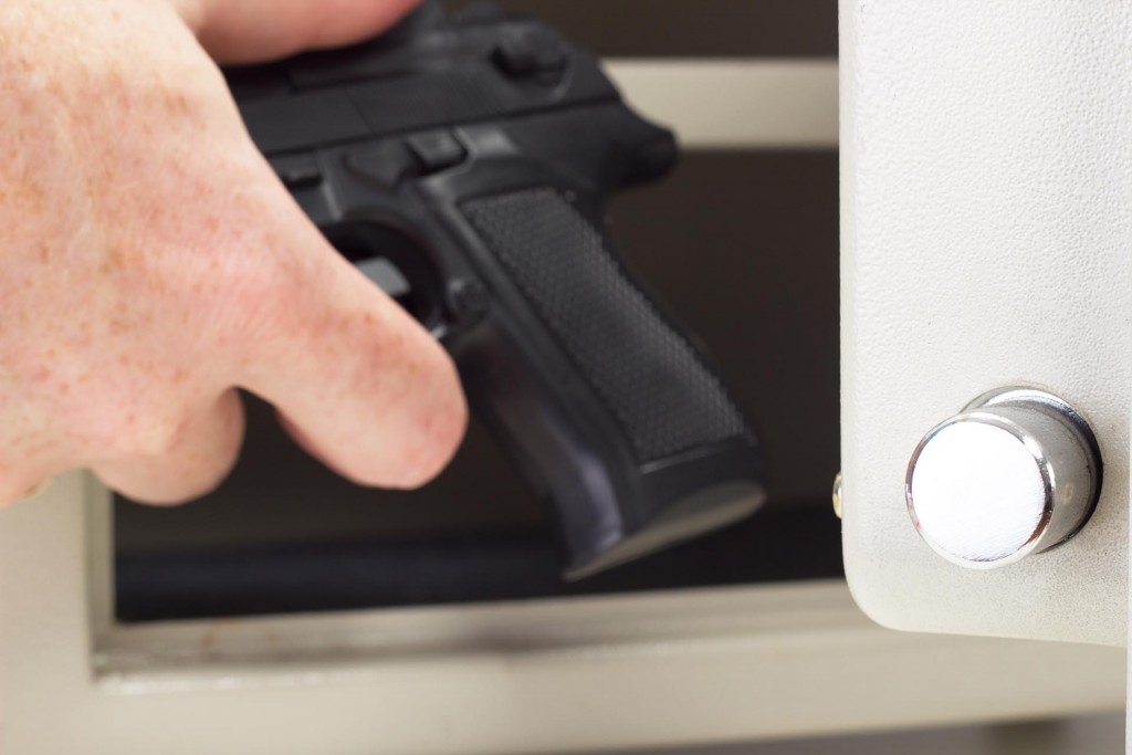Handgun Being Placed In a Gun Safe